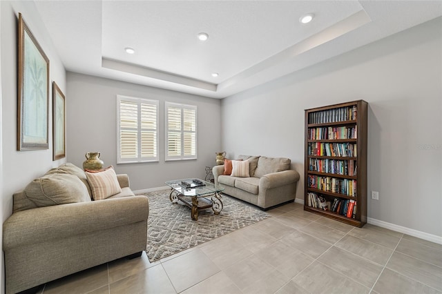 tiled living room with a raised ceiling