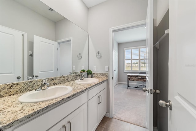 bathroom featuring tile patterned flooring and vanity