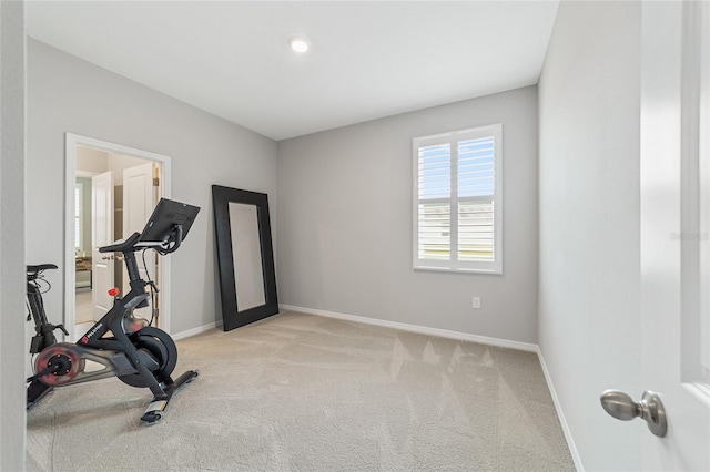 exercise room featuring light carpet