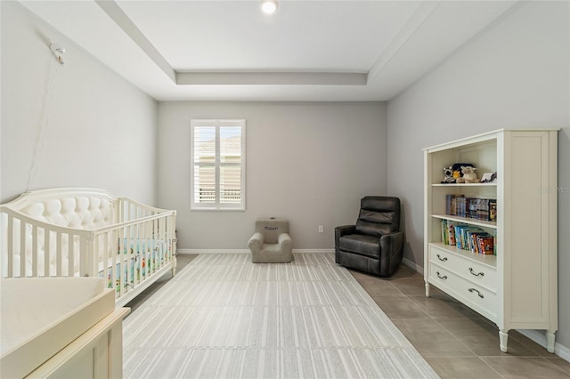 tiled bedroom with a raised ceiling and a nursery area