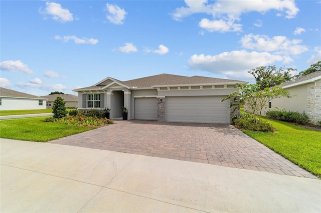 ranch-style home featuring a garage and a front yard