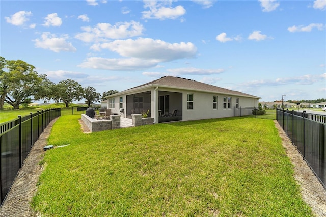 rear view of property featuring a lawn and a sunroom