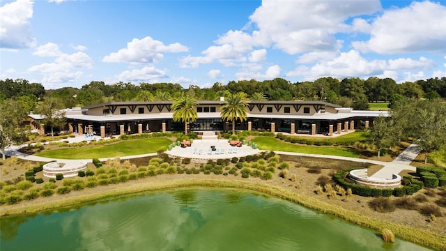 back of property featuring a water view