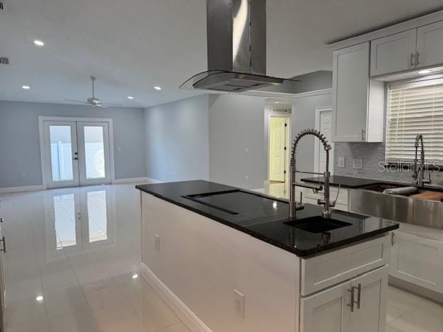 kitchen with white cabinets, sink, and ventilation hood