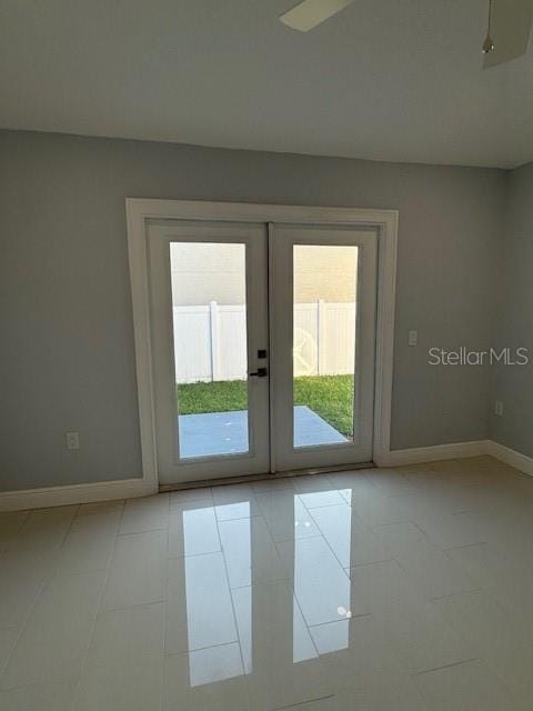 doorway with french doors and light tile patterned floors