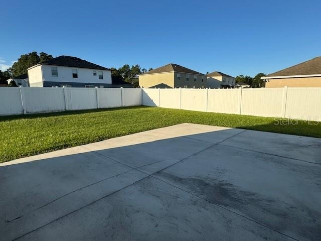 exterior space with a patio and a lawn