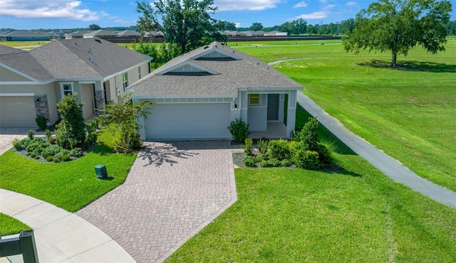 view of front facade with a front yard and a garage