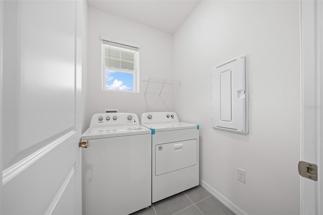 laundry room with light tile patterned floors, separate washer and dryer, and electric panel