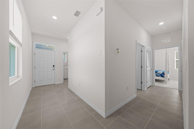 hall with light tile patterned floors