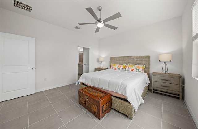 tiled bedroom with ceiling fan and ensuite bath