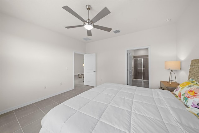 tiled bedroom featuring ceiling fan and ensuite bath