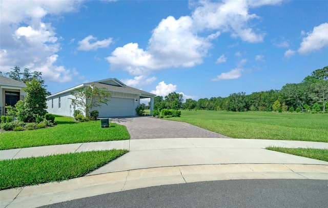 view of front of home with a garage and a front lawn