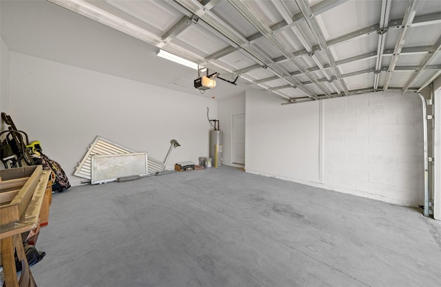 garage featuring water heater and a garage door opener