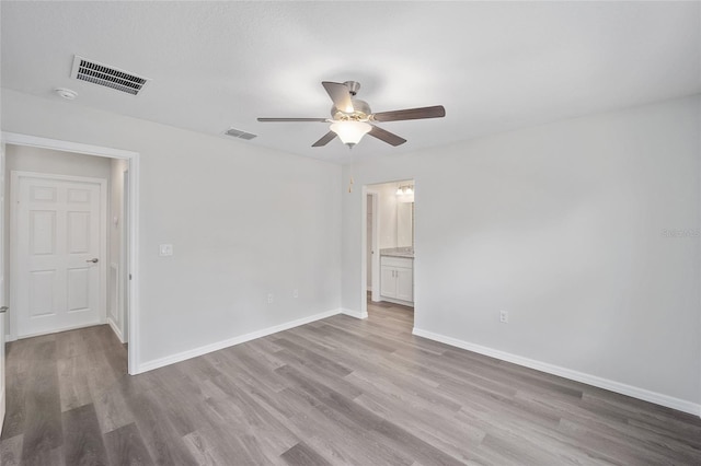 empty room featuring ceiling fan and light hardwood / wood-style flooring