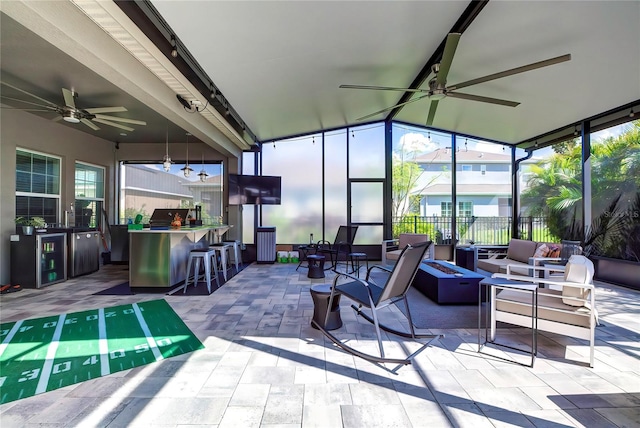 sunroom with ceiling fan and plenty of natural light