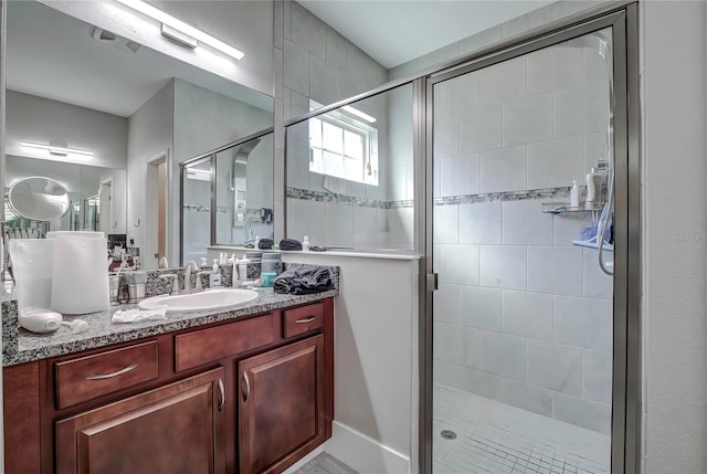 bathroom with an enclosed shower and vanity