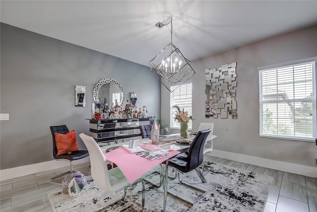 dining area with a notable chandelier and light hardwood / wood-style floors