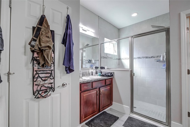 bathroom with walk in shower and vanity