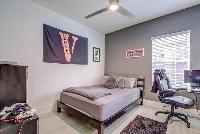 bedroom with ceiling fan and light hardwood / wood-style flooring