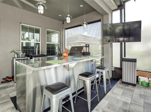 kitchen featuring a kitchen breakfast bar, kitchen peninsula, radiator, and pendant lighting