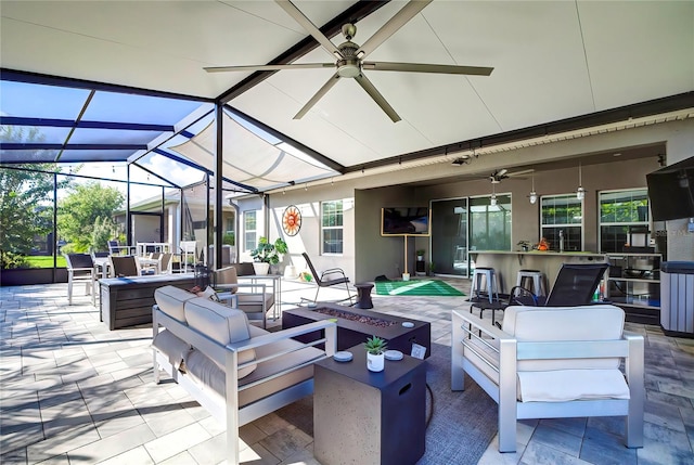 view of patio / terrace featuring ceiling fan, an outdoor hangout area, and glass enclosure