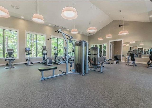 workout area featuring high vaulted ceiling