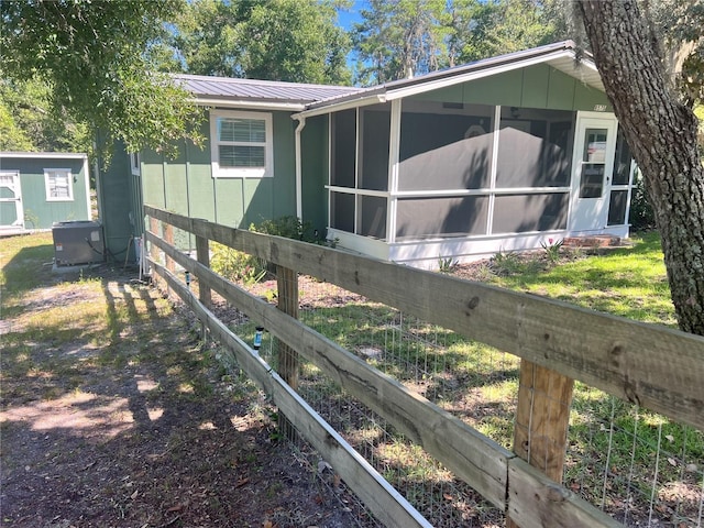 view of side of home with a sunroom