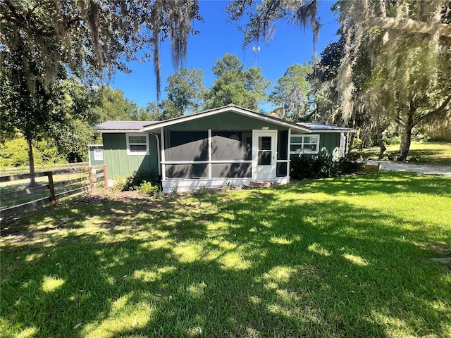 rear view of property with a lawn