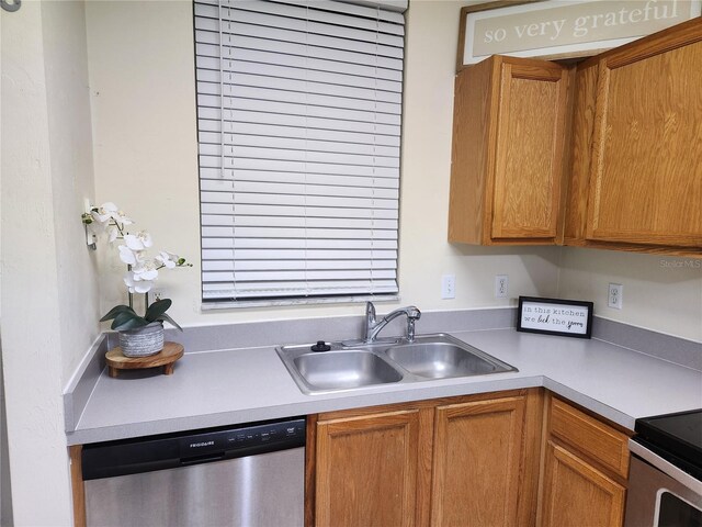 kitchen featuring range, stainless steel dishwasher, and sink