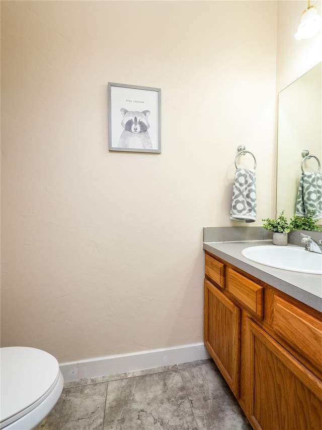 bathroom with tile patterned floors, vanity, and toilet