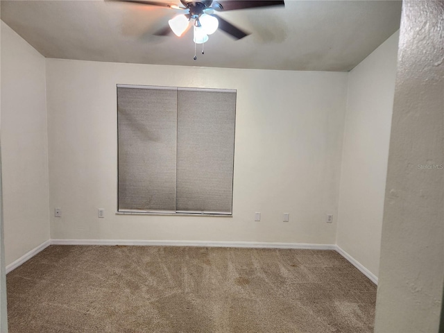 unfurnished room featuring ceiling fan and carpet