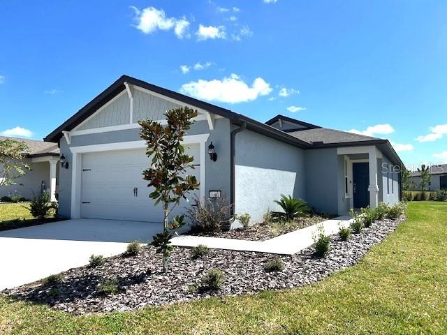 view of front of home with a front lawn and a garage