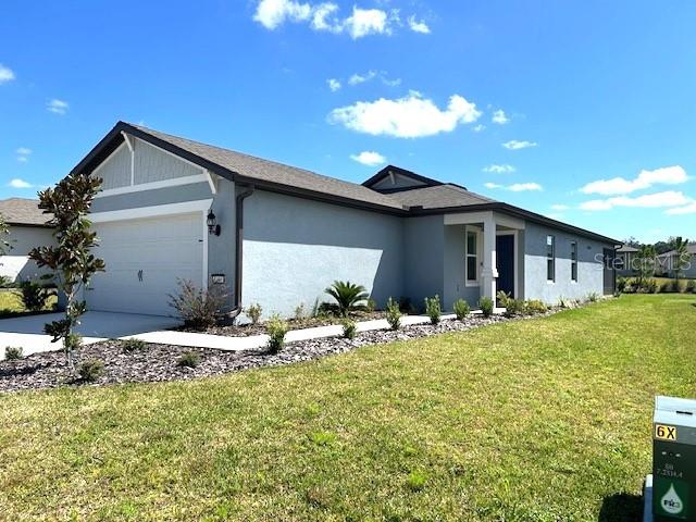 view of front facade featuring a garage and a front lawn