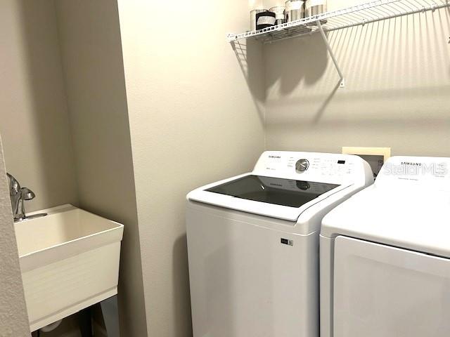 washroom featuring separate washer and dryer and sink