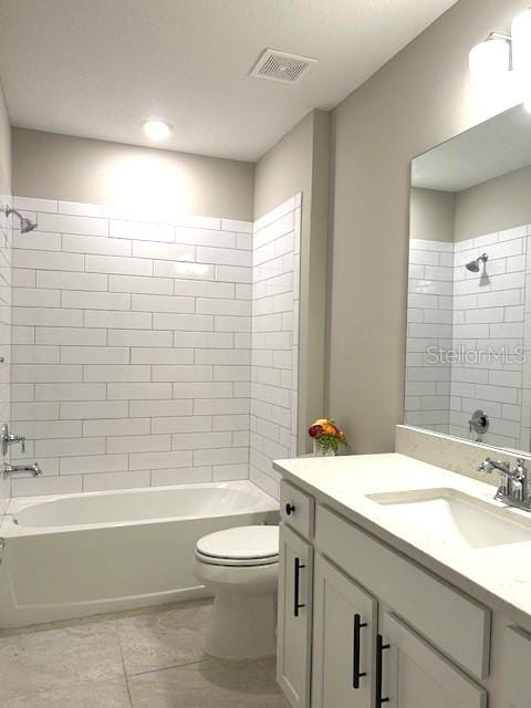 full bathroom featuring vanity, toilet, and tiled shower / bath