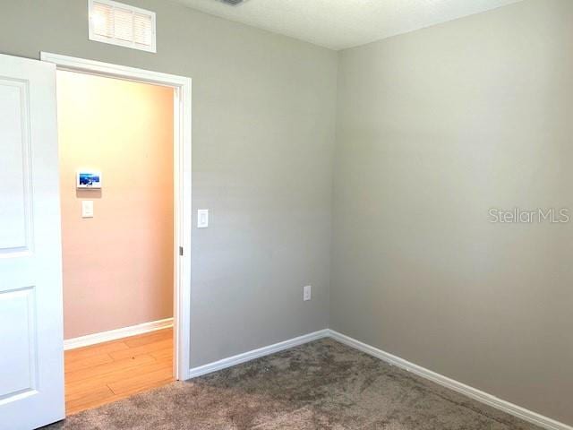 spare room with hardwood / wood-style flooring