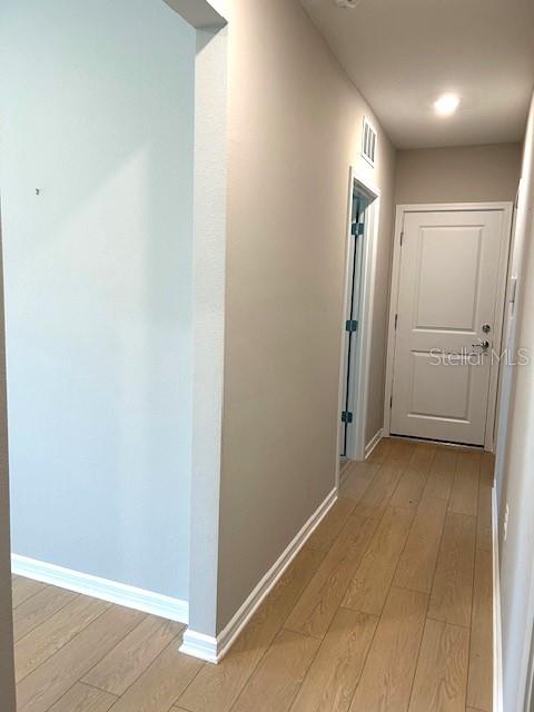 corridor featuring light hardwood / wood-style floors