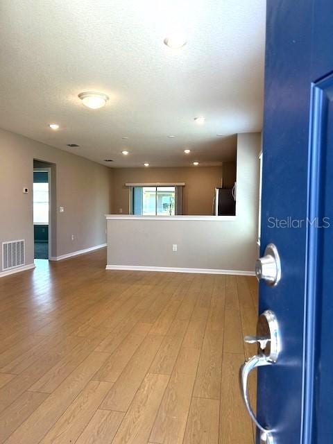 unfurnished living room featuring hardwood / wood-style floors