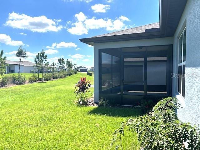 view of yard featuring a sunroom