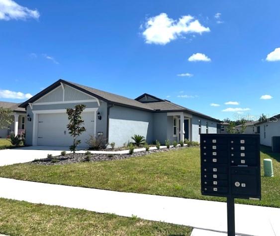 view of front of house featuring a garage and a front lawn