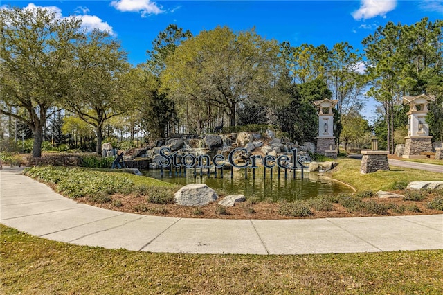 view of community featuring a lawn and a water view