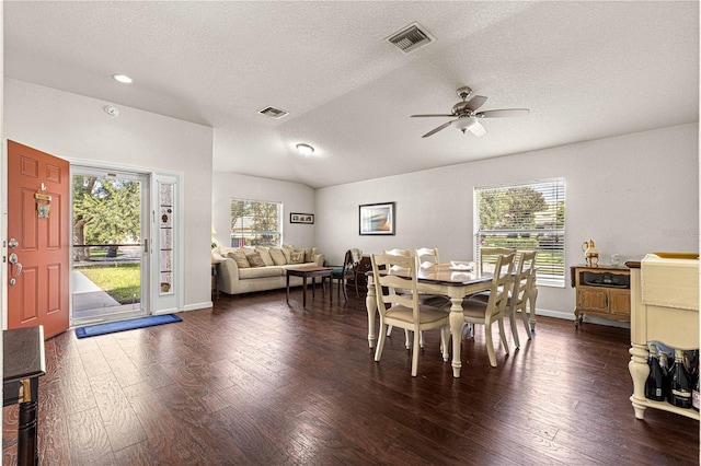 dining space featuring ceiling fan, a textured ceiling, lofted ceiling, and dark hardwood / wood-style flooring