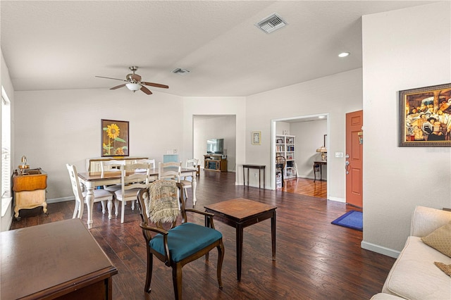 dining room featuring lofted ceiling, ceiling fan, and dark hardwood / wood-style floors