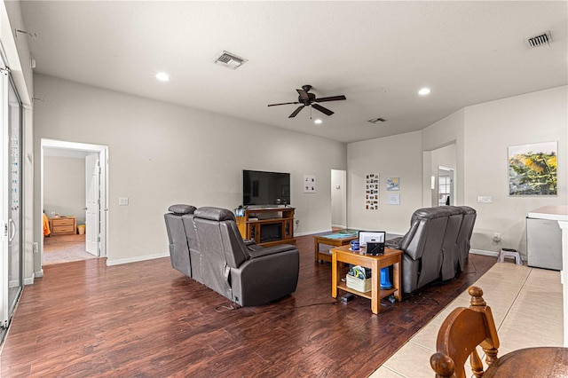 living room featuring dark hardwood / wood-style floors and ceiling fan