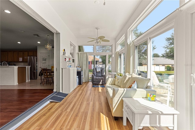 sunroom / solarium featuring ceiling fan and a wealth of natural light