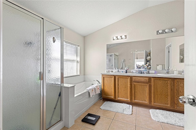 bathroom featuring vanity, a textured ceiling, plus walk in shower, tile patterned floors, and vaulted ceiling