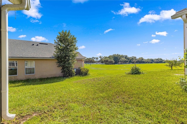 view of yard featuring a rural view and central AC