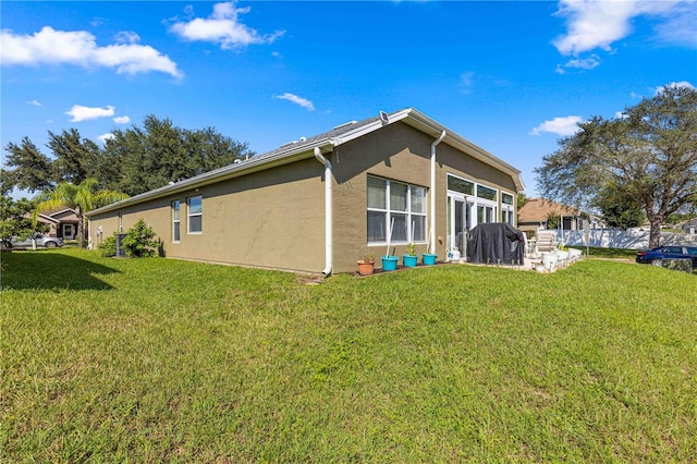 view of side of home featuring a yard