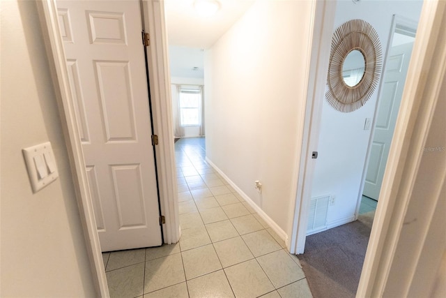 corridor with light tile patterned floors