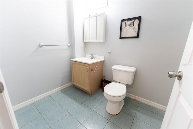 bathroom with tile patterned flooring, vanity, and toilet